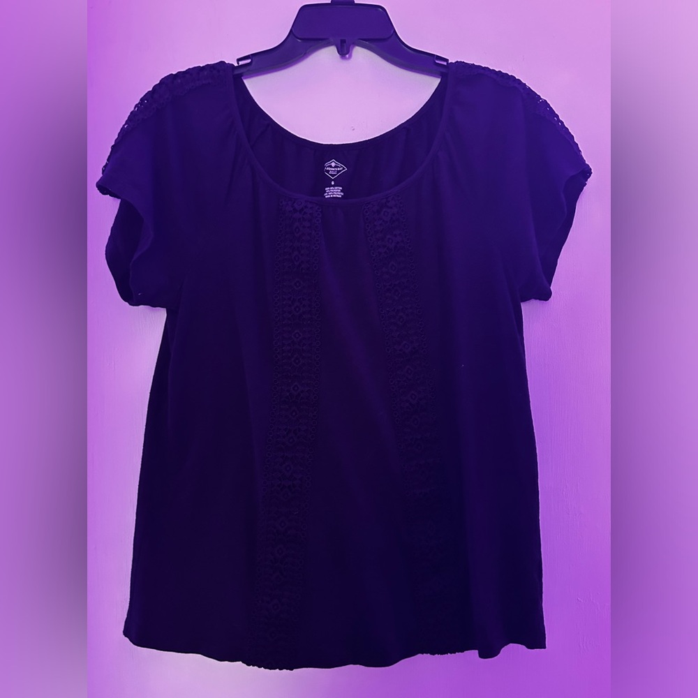 This is a Johns Bay small black shirt with detailing down the front and sleeves.